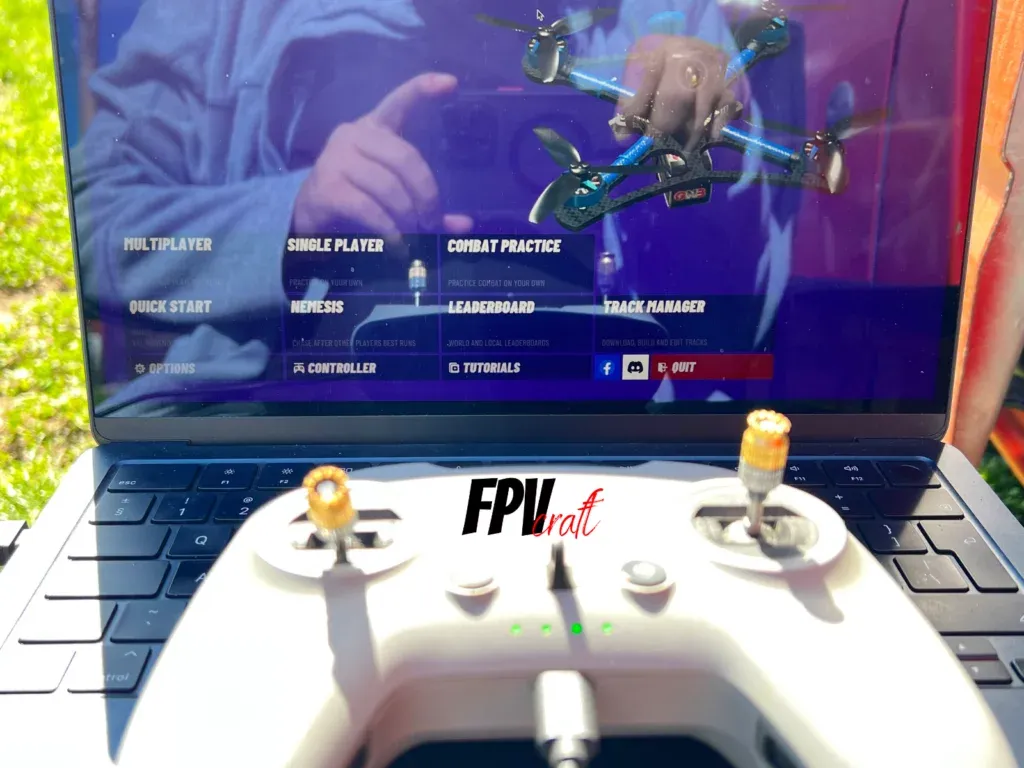 DJI FPV Remote Controller 2 in front of the laptop with VelociDrone simulator loaded